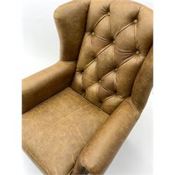 Georgian style wing back armchair upholstered in buttoned and studded tan leather, scrolling arms, square tapering supports 