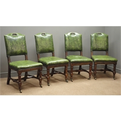  Set four Edwardian oak dining chairs, studded and upholstered in dark green leather, faceted supports and stretchers on castors  