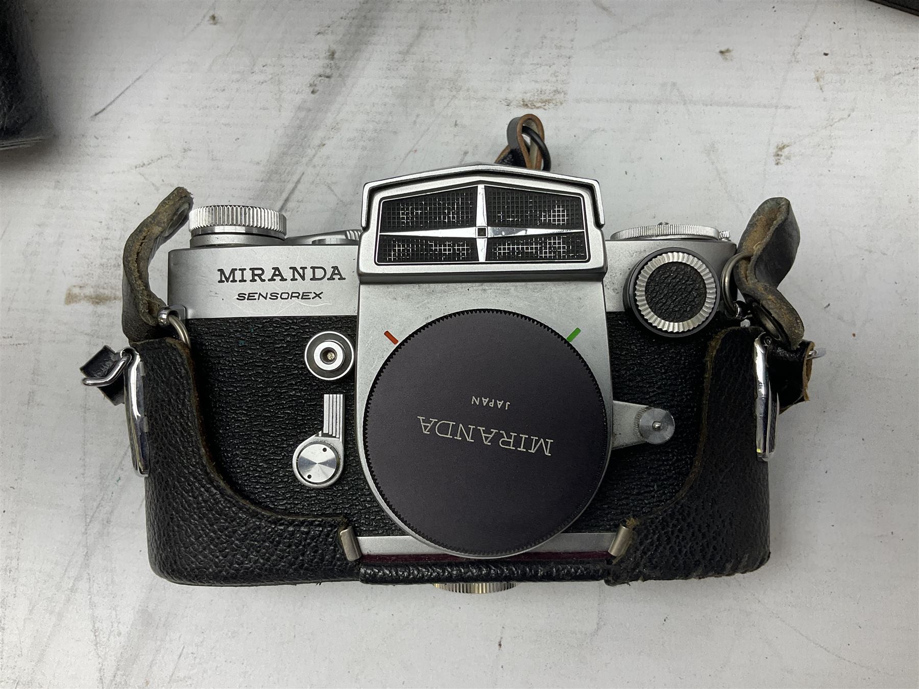 Miranda Sensorex camera body, Miranda Sensorex II camera body with 'Auto Miranda 1:1.8 f-59mm' lens, 'Auto Miranda 1:2.8 f-135mm' lens, 'Auto Miranda 1:3.5 f-200mm' lens, 'Auto Miranda 1:2.8 f-28mm' len, Agfa plate camera with 9cm x 12cm plates and other camera equipment including Miranda camera bag