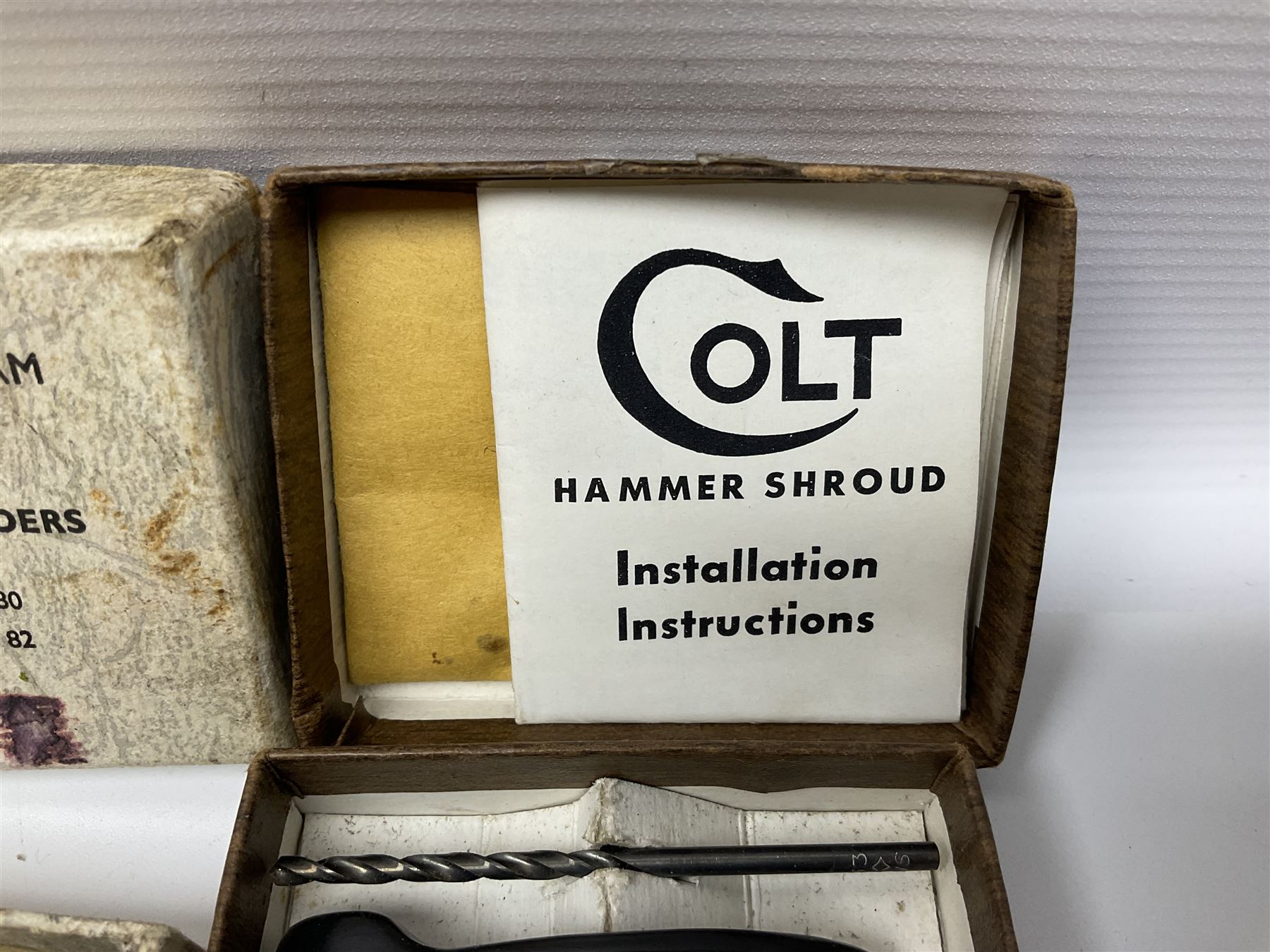 Six pairs of revolver grips;  pair of Lightwood & Son Ltd powder/shot measures in original box; and boxed Colt hammer shroud 