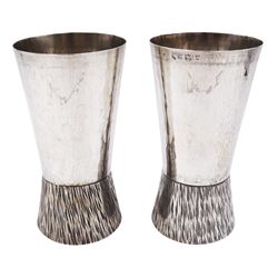 Pair of modern Guild of Hull Silversmiths silver goblets, the bowls each of tapering cylindrical form, with spot hammered finish, upon a tapering foot, etched with abstract lines, hallmarked J & KR, Birmingham 1983, also marked with the three crowns mark of the Guild of Hull Silversmiths, H11.6cm
Notes: Abraham Barachin was the last Hull silversmith to use the Hull mark of three ducal coronets in around 1706. However in 1983 the Assay Offices of Great Britain and the City of Kingston upon Hull granted the Guild of Hull Silversmiths permission to use the City's Coat of Arms as an additional mark on pieces they produced