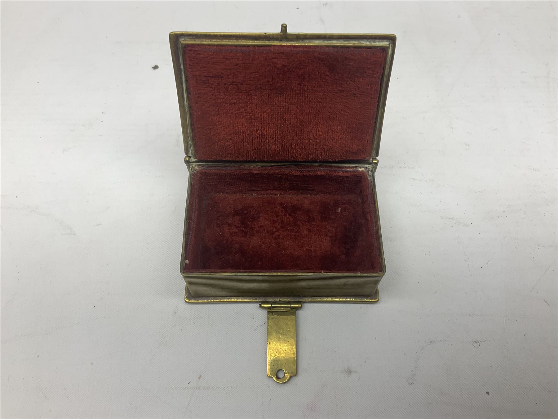 Collection of victorian and later brass desk accessories, to include a letter holder with cherub design, ink well of square form with hinged lid, brass table bell, brass casket with relief decoration, etc  