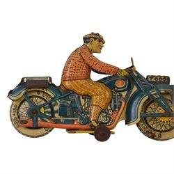 Tipp & Co tinplate clockwork motorcycle no. T686, the motorbike in dark blue with Dunlop cord wheels in cream, the civilian rider in orange clothing, H12.5cm ,W19cm