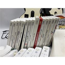 Nintendo Wii console, four controllers with cases and four nunchucks, Wii sensor bar, balance board and dance mat. Guitar hero wireless guitar for Wii and Redoctane wired guitar. Nintendo DS lite handheld gaming console, console and game cases and Guitar Hero Redoctane Guitar Grip. Selection of Nintendo Wii and Nintendo DS lite games to include Super Mario Galaxy, Guitar Hero, Wii Fit, Legend of Zelda games etc. Archos AV400 Series pocket video recorder with accessories, cradle and remote, in three boxes