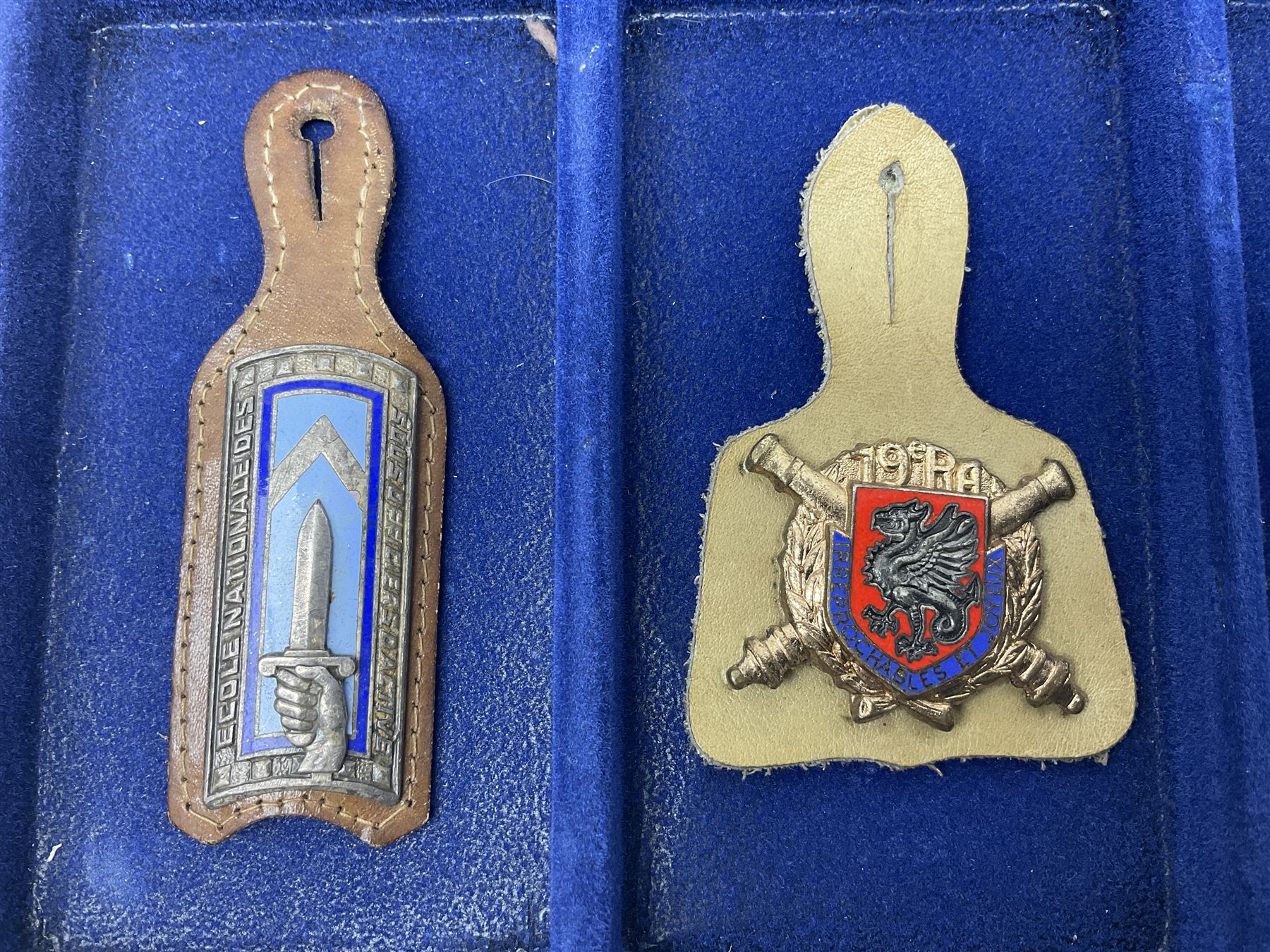 Twelve French military metal badges mounted on leather fobs including Legion, Artillery, Parachutist, Air Force, Infantry etc