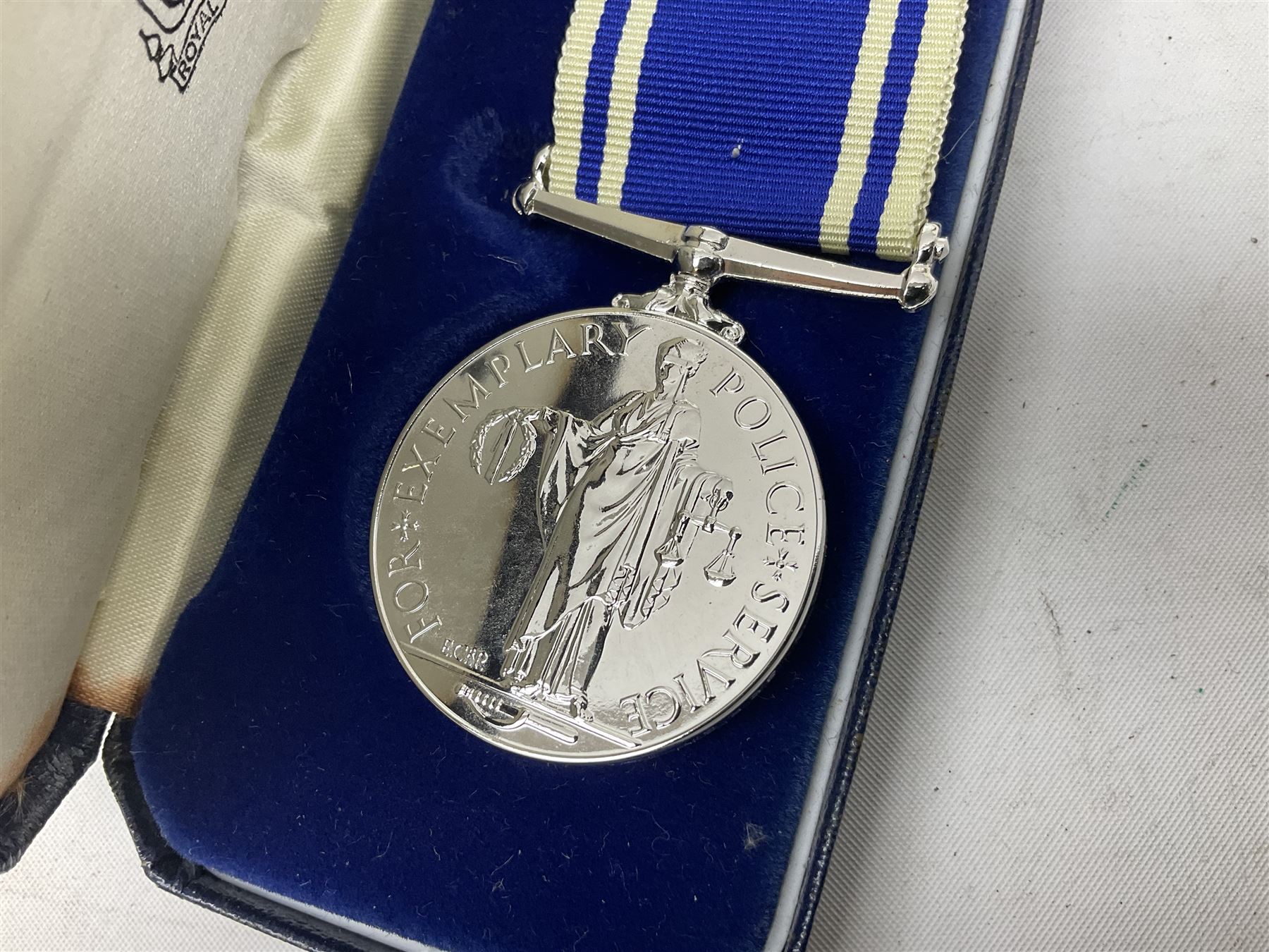 Archive of memorabilia and ephemera relating to Pc. (later Sgt.) Geoffrey Robinson of Dewsbury (later West Yorkshire) police force including cased Long Service and Good Conduct Medal; helmet plates and cap badges, collar numbers and uniform buttons, whistles, certificates, photographs, plaque etc 1960s - 1990s