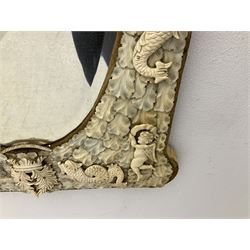 Pair 19th century French Dieppe bone and ivory wall mirrors, the oval bevelled mirror plates within rectangular frames with shaped tops, profusely decorated with ivory leaves, further detailed with carved bone armorial type crest inscribed 'SGOTORVM', putti, fish and mask heads, H81cm W48cm