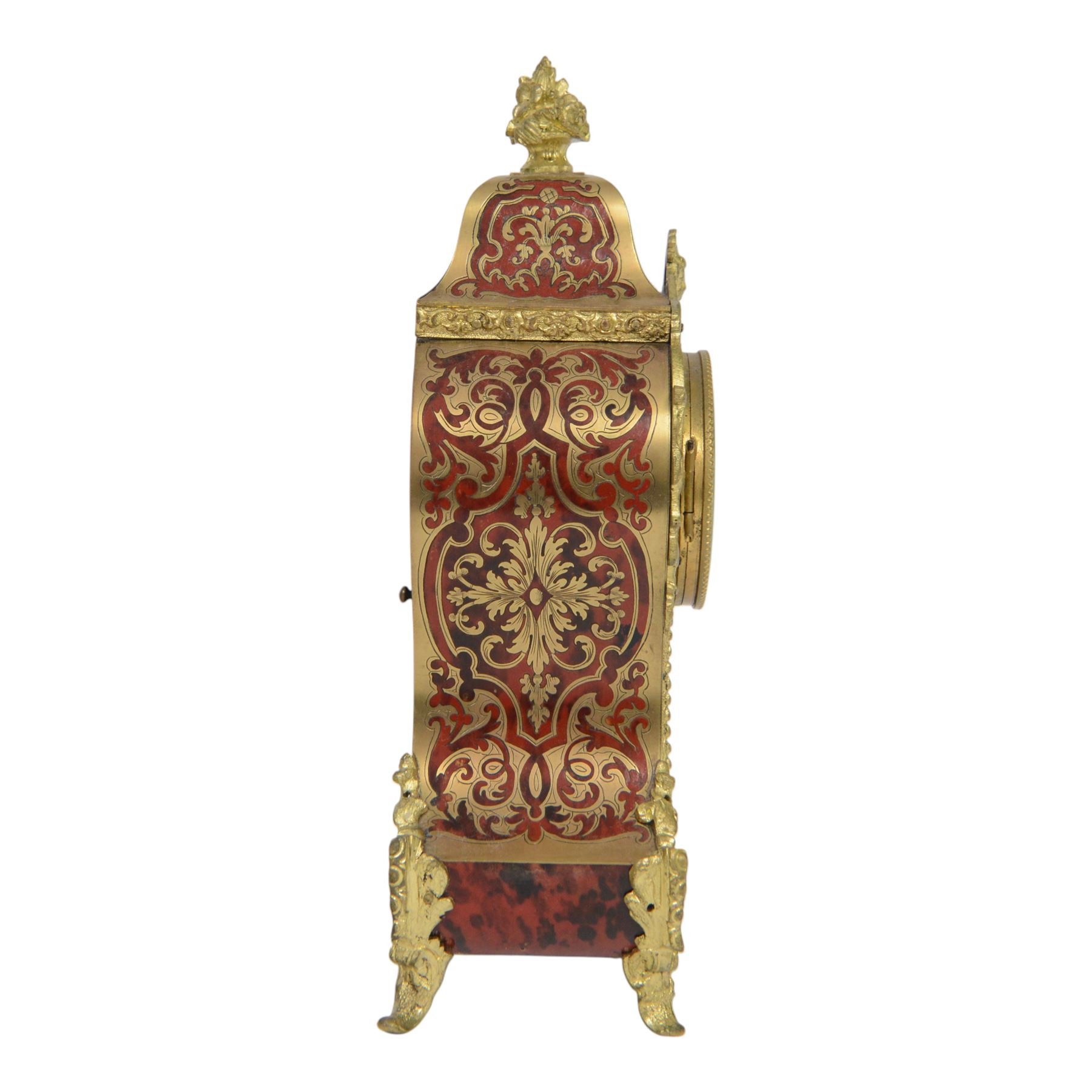 Louis XV-style gilt-bronze mounted turtleshell boulle mantel clock, the case of typical waisted form, gilt bronze foliate scroll and rocaille mounts, raised on scroll feet. Eight-day Paris movement signed “Rollin à Paris”, with outside count-wheel striking half-hourly on a single bell, the going train with anchor escapement. The circular foliate gilt bronze dial with enamelled Roman hour numerals and twin winding apertures, fitted with pierced blue steel hands and bevelled glass cover, with pendulum and key, circa 1860