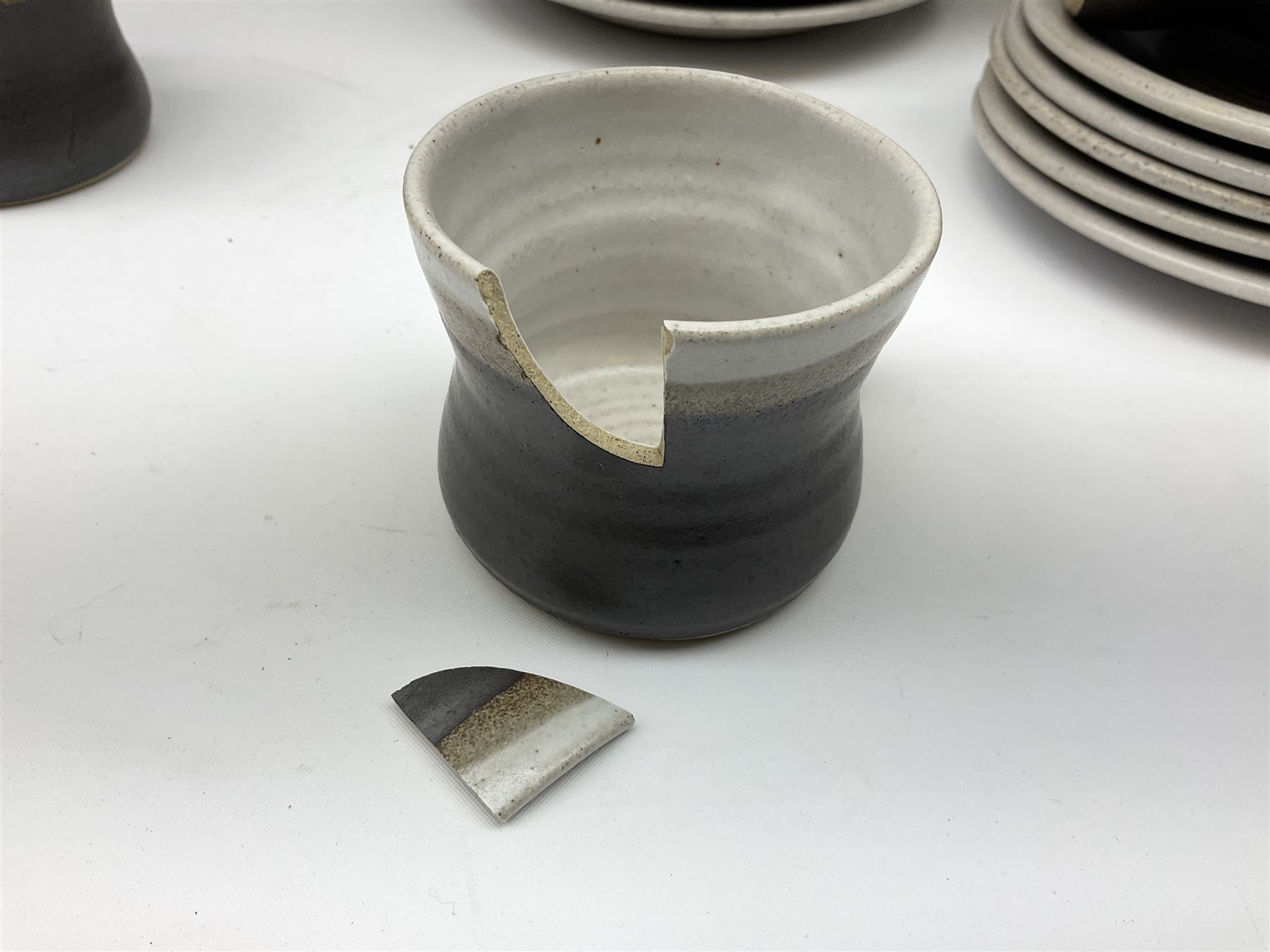 Marianne De Trey (British 1913-2016) stoneware coffee service for twelve, together with a large deep stoneware footed bowl and ladle with wood handle, all decorated in Manganese 'Pattern 1' with impressed shell marks, bowl D27cm