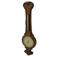 Late-19th century oak cased wheel barometer, 8” silvered dial with weather predictions, recording air pressure from 28 to 31 inches, steel indicating hand and brass recording hand, within a convex glass and cast brass bezel, with a removable mercury thermometer box, mercury capillary tube and counterweights.

