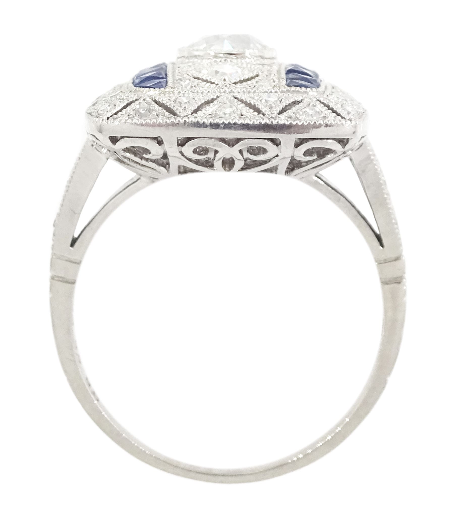 Platinum milgrain set diamond and sapphire ring, the principal old cut diamond of 0.53 carat, with pierced design, single cut diamond and calibre cut sapphire surround, stamped Plat, total sapphire weight 0.30 carat 
