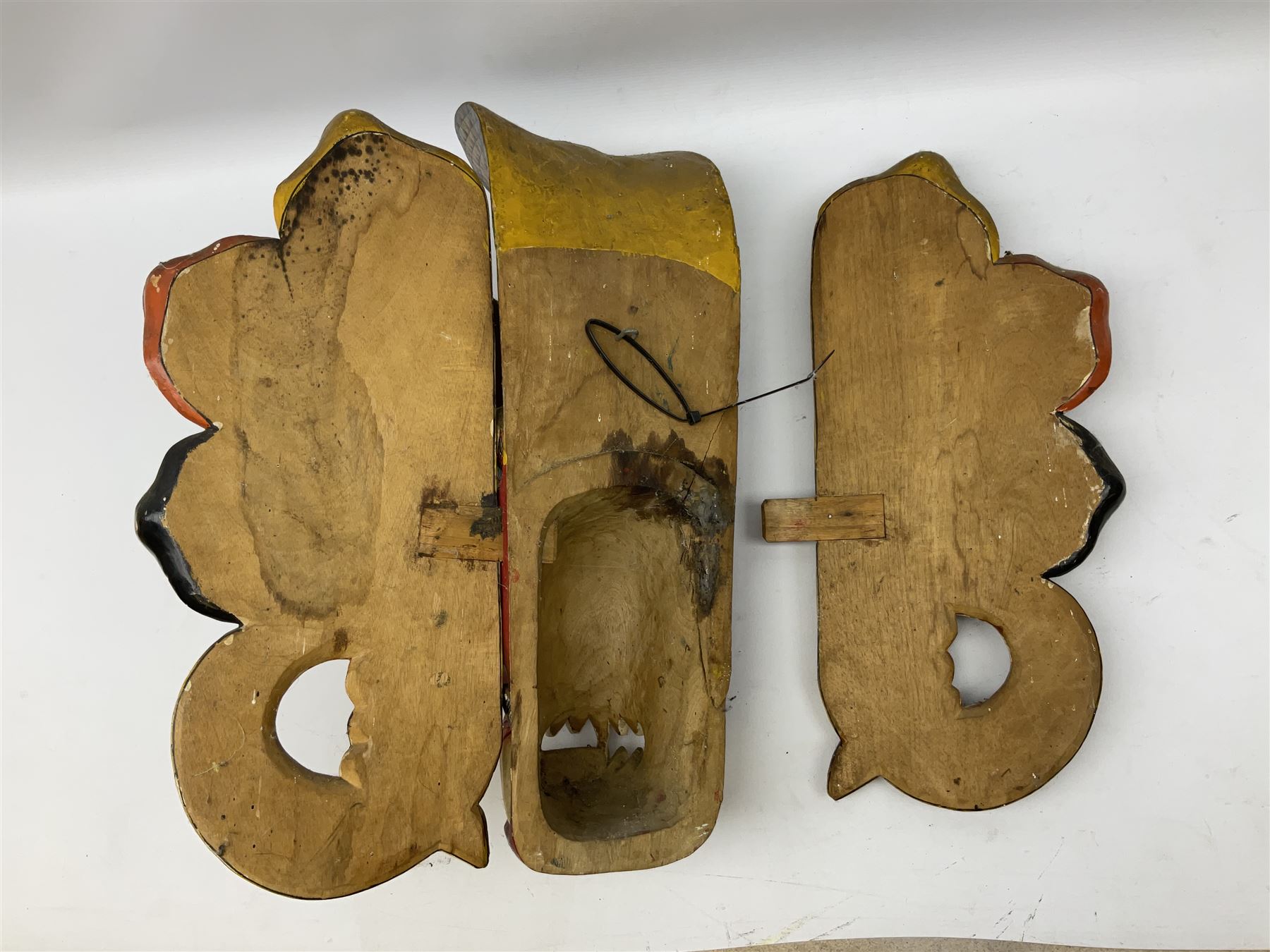 Sri Lankan Cobra mask depicting the demon Naga Raksha, together with a smaller example, largest H46cm