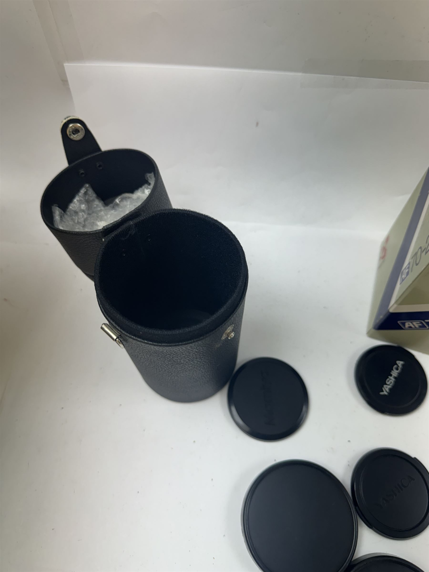 Group of camera lenses, comprising Yashica AF 70-210mm 1:4.5 58mm lens serial no. F6106983, boxed, Yashica AF 35-70mm 1:3.3-4.5 52mm Macro lens serial no. F60231147, Yashikor Aux Wide Angle 1:4 lens and a Yashikor Aux Tele-Photo 1:4 lens, Mamiya-Sekor E 1:2.8 f=28mm serial no. 13427 and a Mamiya-Sekor Zoom E 1:4 f=80-200mm lens serial no. 11271