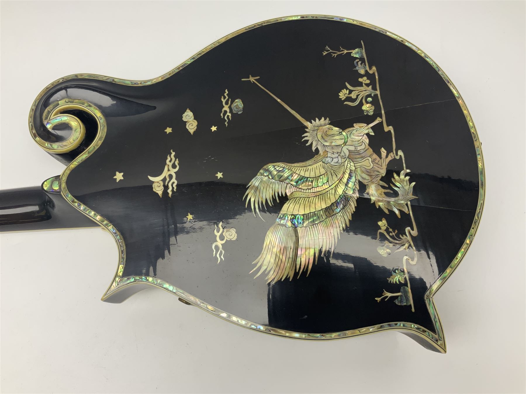 Eastern F-hole eight-string mandolin with black finish and mother-of-pearl inlay of a man riding a winged horse/unicorn amongst clouds and stars with playing card suits to the fingerboard L71cm