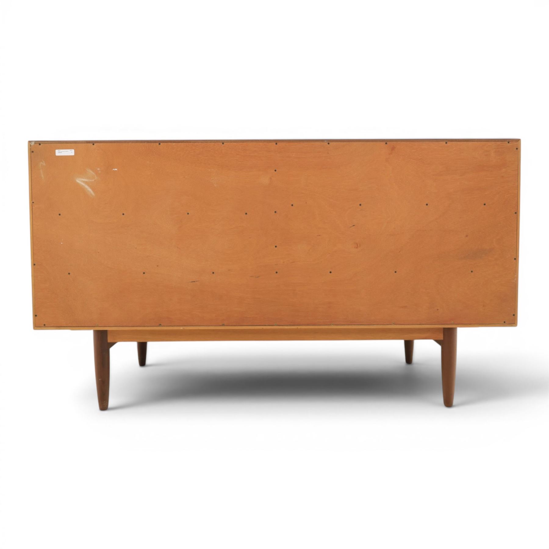 G-Plan - 'Brasilia' teak sideboard, with rectangular top above two concertina doors, above four drawers raised on cylindrical supports