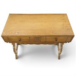Leemings of Halifax (est. 1872) - Arts & Crafts oak side table, rectangular caddy top with raised moulded back, the frieze carved with central Yorkshire rose motif flanked by two drawers, raised on twin stylised lyre end supports formed of C-scrolls, united by shaped stretcher