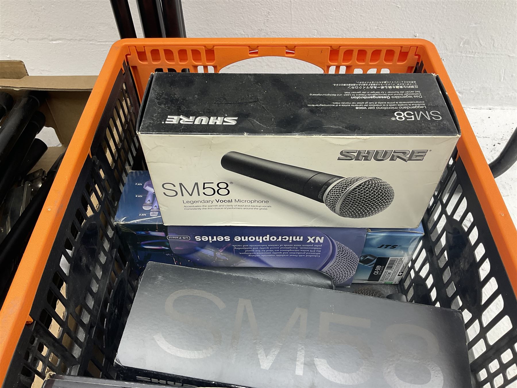 Two Shure SM58 microphones, Gatt Audio DM-700 microphone, other boxed and unboxed microphones and various microphone and music stands