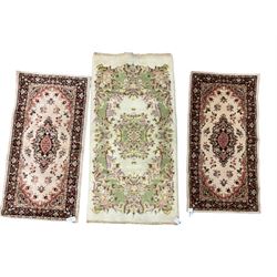 Chinese ivory ground rug, decorated with floral patterns (138cm x 73cm); and pair Persian design rugs (116cm x 60cm)