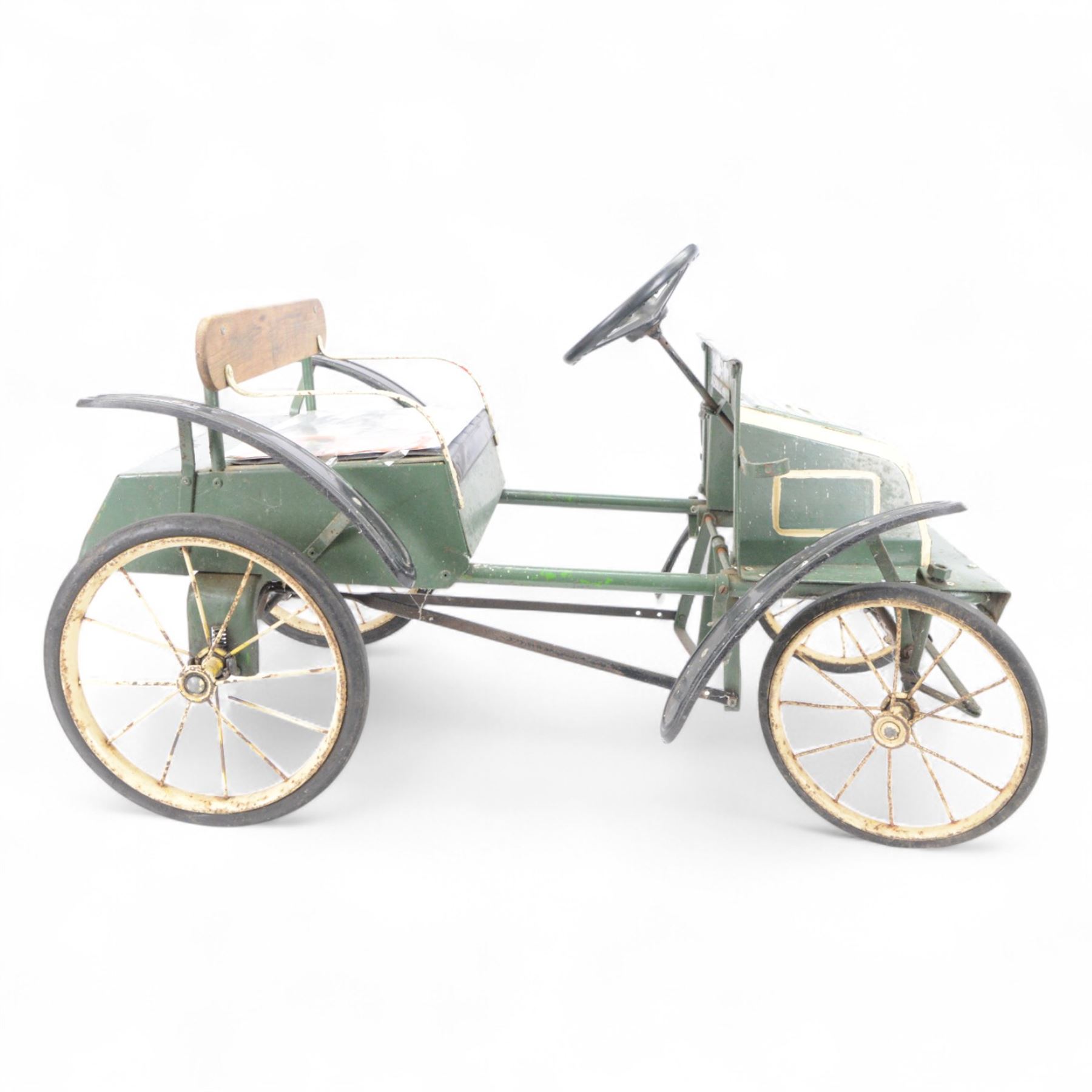 Triang child's pedal car in the style of a vintage automotive, likely a De Dion Bouton or an early Renault, painted in dark green with pale yellow details, H52cm