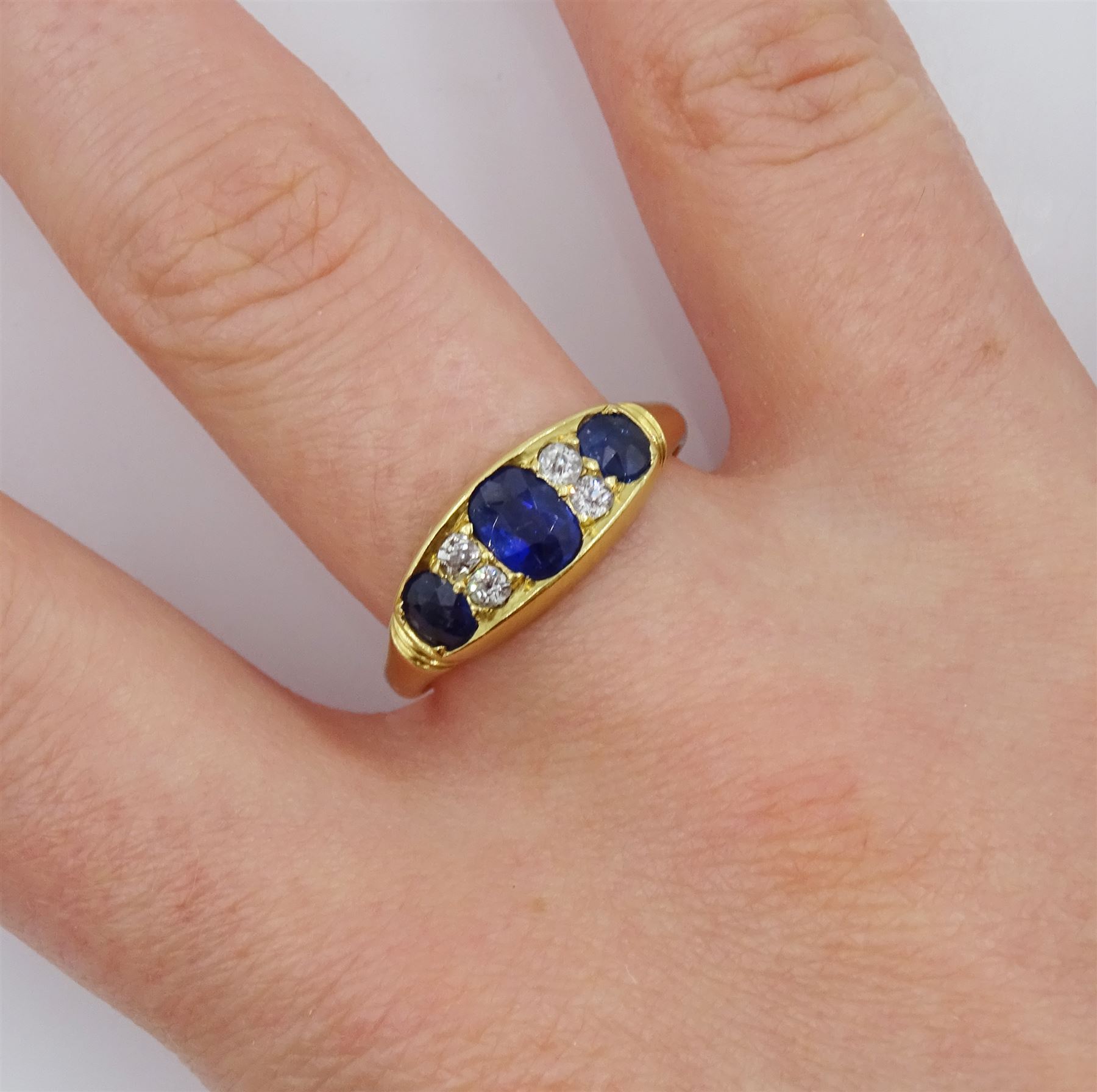 Victorian 18ct gold three stone oval sapphire ring, the central sapphire with two old cut diamonds set either side, Birmingham 1898, total sapphire weight approx 1.00 carat