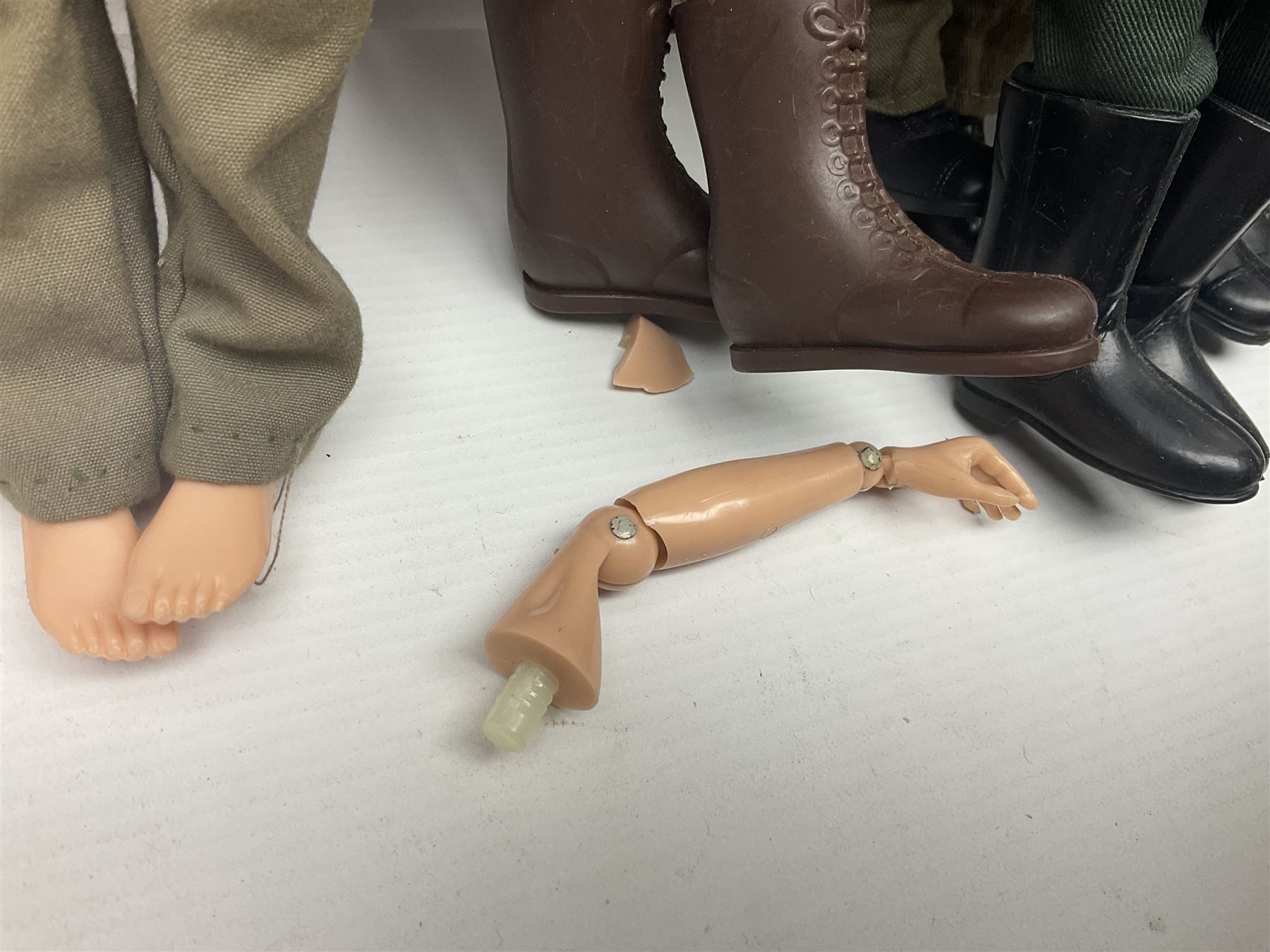 Action Man - five figures marked on the back 'Made in England by Palitoy under licence from Hasbro 1964', one dressed as a German Stormtrooper, one as a Red Devil Pilot and three in army uniform; another similar action figure marked to the right buttock ' G.I. Joe Copyright 1964 by Hasbro Patent Pending Made in Canada' dressed in army uniform; together with an Action Man jeep, field gun, mortar and machine guns and other accessories including helmets and weapons, parachute, diving equipment, skis and snow shoes, boots, uniforms etc; all unboxed