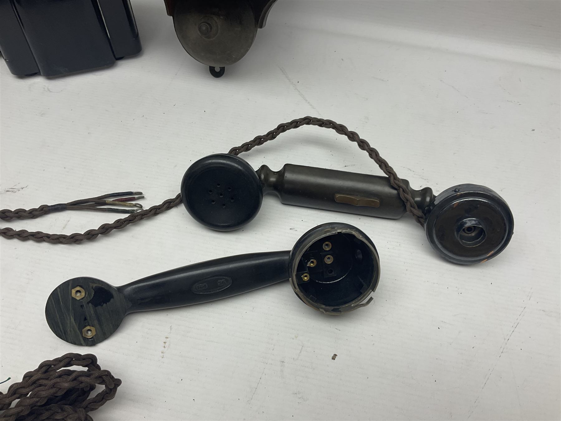 Collection of phone headsets, including GPO bakelite examples, together with other telephone parts 