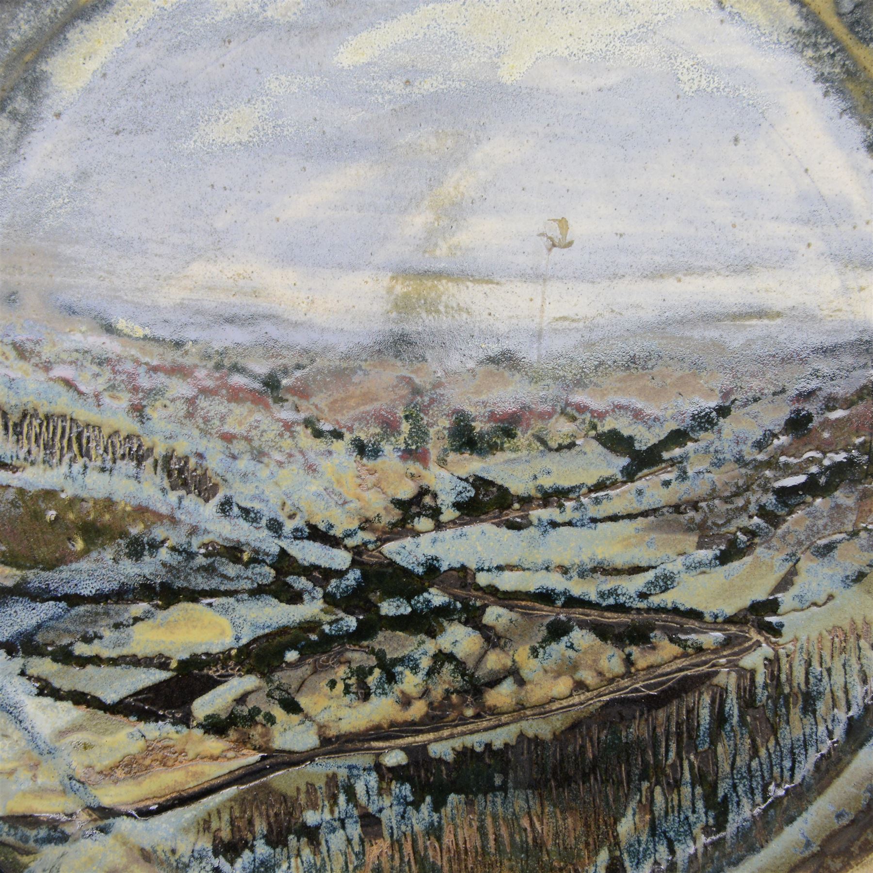 John Egerton (c1945-2024): studio pottery charger, decorated with a moorland view D32cm