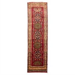 North West Persian Tariz hand-knotted runner, madder red field with a column of linked loz...