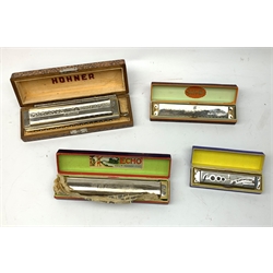 A group of four cased Harmonicas, comprising a Hohner 64 Chromonica, a Hohner Echo, a Hohner Song Band, and a Band Master Fancy. 