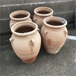 Set four ribbed terracotta urns with three handles, H51cm