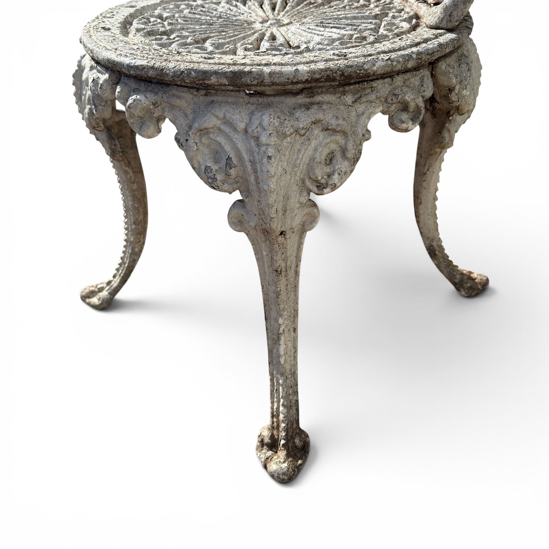 Pair of white painted cast metal garden chairs, ornate reclined backs, circular pierced seats on cabriole legs