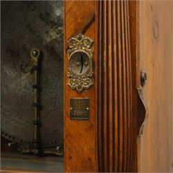 Late 19th century coin operated floor standing Polyphon, the shaped cornice marked 'Polyphon' with eleven 50cm discs in a walnut case with glazed upper section, the coin slot marked '1 Penny', the lower section with fall front for disc storage and inset with a portrait print and on compressed bun feet H230cm x W76cm x D46cm with a number of old pennies