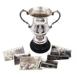1920s silver trophy, of typical form, with twin acanthus capped scroll handles, upon circular stepped foot and ebonised wooden base, engraved to body 'Autumn Trial Scarboro Fell Cup 1923 Geo. Jackson' and accompanied by pictures of people who reputedly took part in the competition and won the trophy, hallmarked Fattorini & Sons Ltd, Sheffield 1921, including handles and base H21.7cm