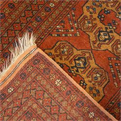 Bokhara red ground rug, the field decorated with three Gul motifs, within multiple borders with repeating geometric patterns (146cm x 103cm); together with an Afghan rug (144cm x 100cm)