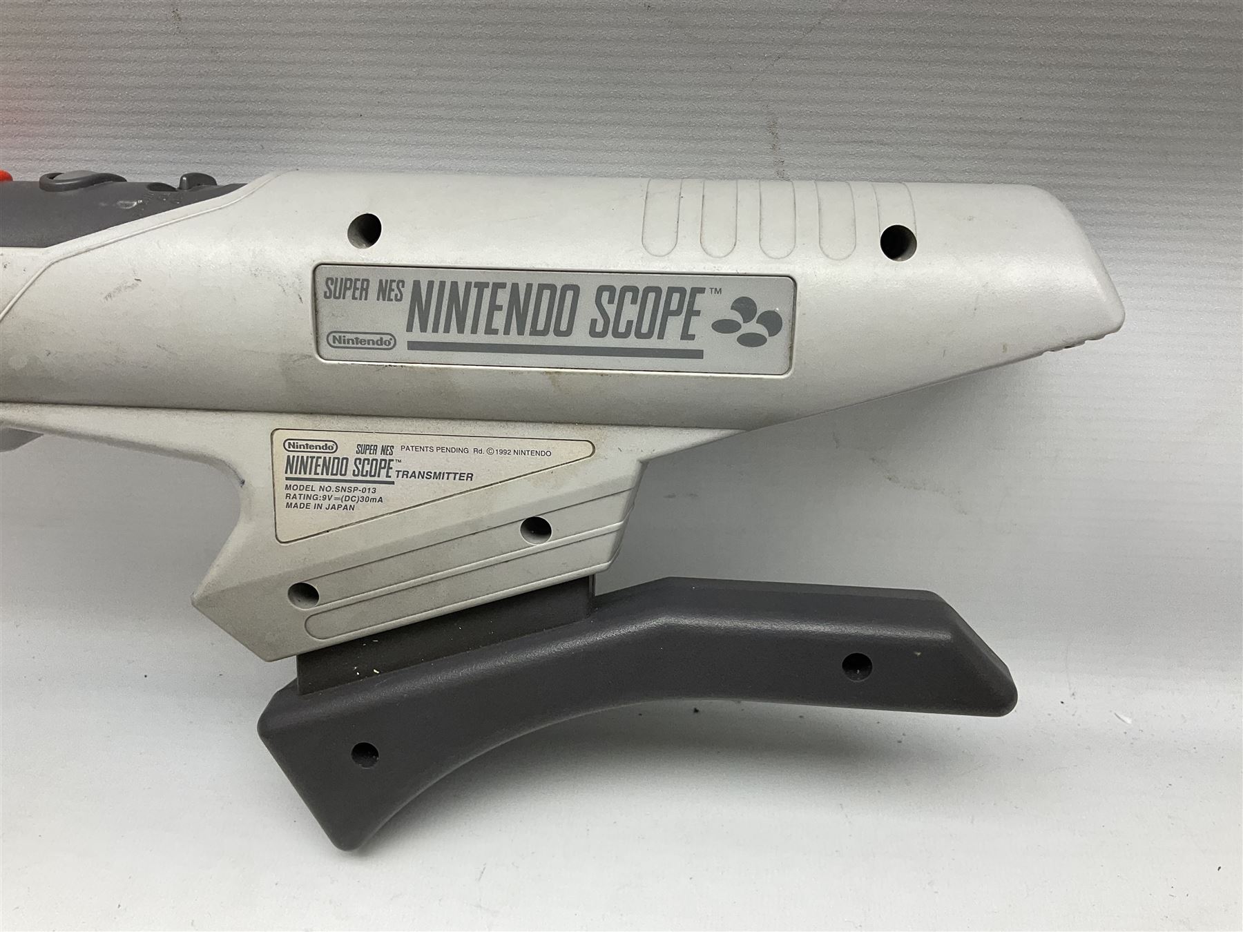 Two Super Nintendo Entertainment System (PAL) controllers, accessories and games. Super NES Game Commander with original box and instruction booklet, Super NES Nintendo Scope (1992) transmitter gun, receiver, Super NES Nintendo Scope 6 game with original instruction booklets. Further games to include ‘The Legend of Zelda a Link to the Past’, ‘Super Mario World’, ‘Super Mario Kart’, ‘The Lawnmower Man’, and ‘Exhaust Heat’, all with original instruction booklets. ‘PowerMonger’ and Disney’s ‘Aladdin’ game cartridges only 