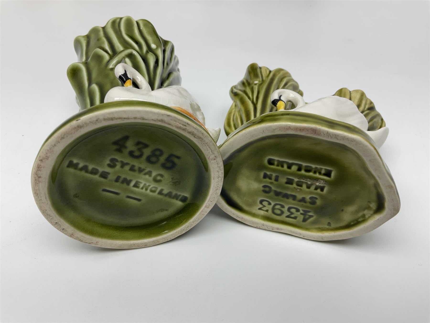 Sylvac budgieregar wall pocket, together with other Sylvac cermics including swan vases, blue tit vase and a frog figure etc, all with printed or impressed marks beneath, and a Poole Pottery cat figure, with printed mark beneath, wall pocket H22cm