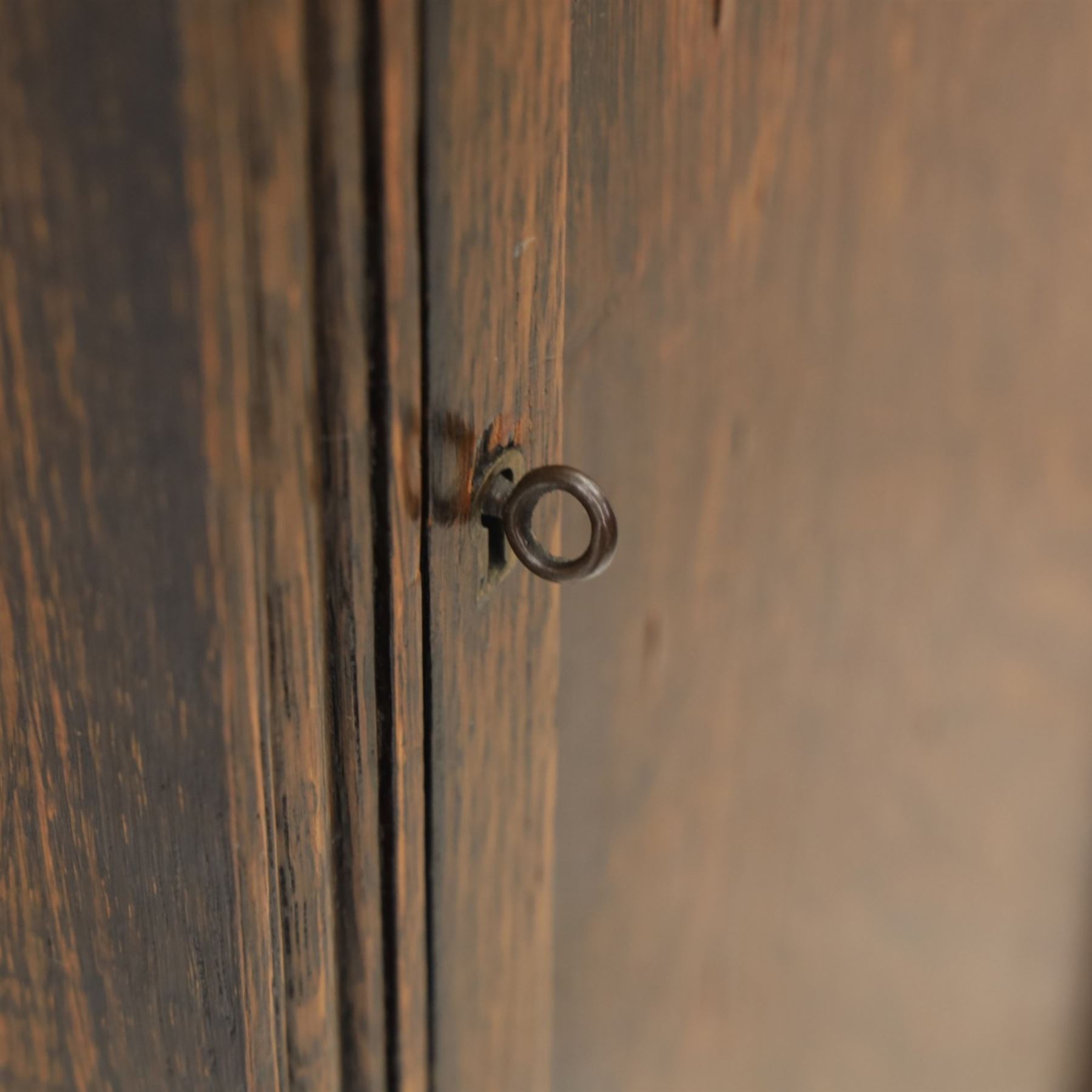 Early 20th century oak longcase clock, square brass dial with engraved foliate spandrels and centre, silvered Roman chapter ring with Arabic minute track, Westminster chime movement, the plain case with glazed arched trunk door and moulded plinth