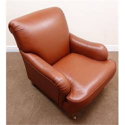  Howard style armchair, upholstered in a chocolate brown leather, turned supports on castors, W80cm  