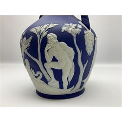 19th century Wedgwood dark blue dipped Jasperware Portland vase, of ovoid form with twin handles to shoulders and waisted neck, and flared rim, the body decorated with a continuous scene of classical figures in relief, the base decorated with portrait in relief, H26cm