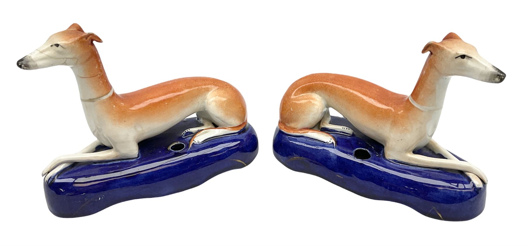 Pair of Staffordshire recumbent greyhound pen holders 