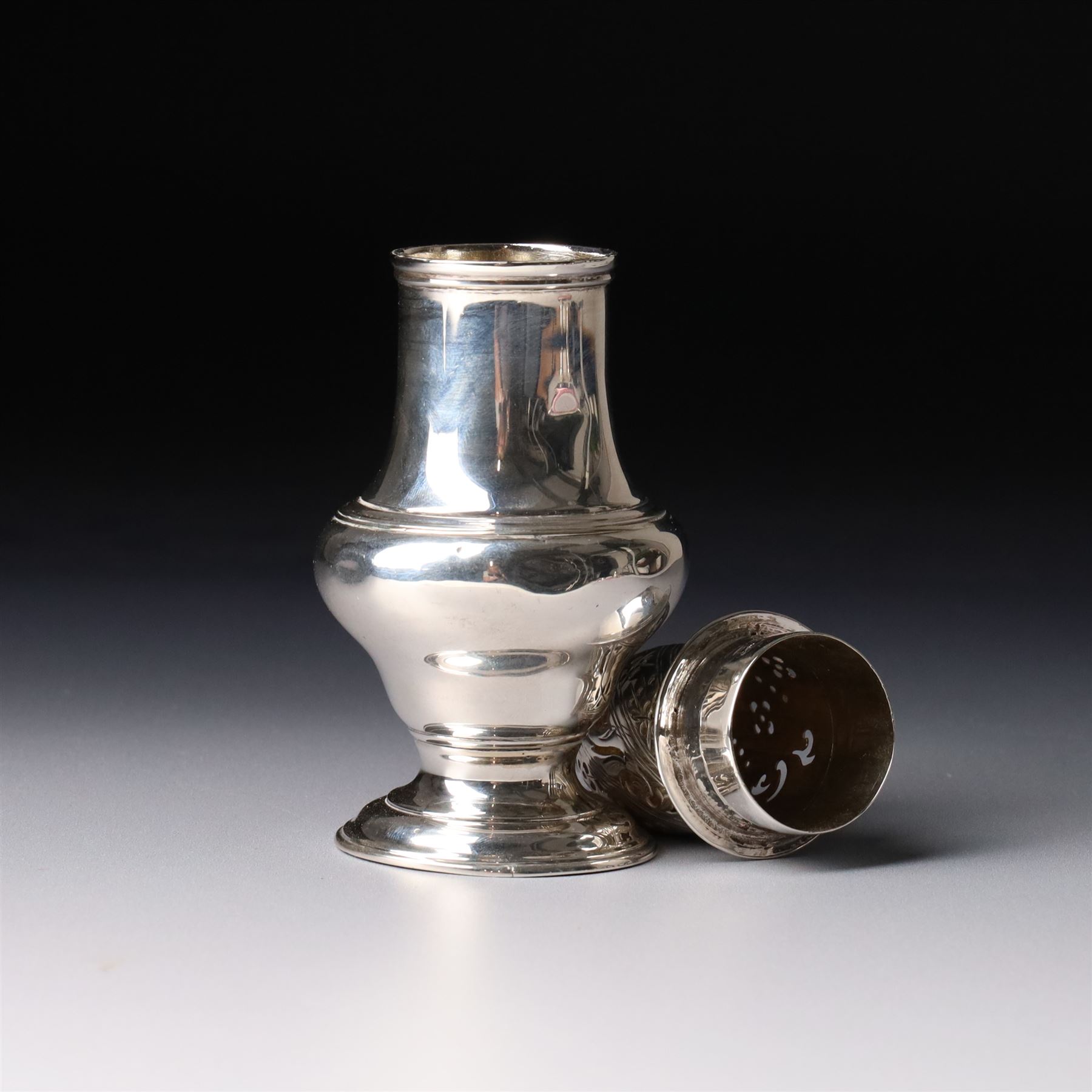 George II silver pounce pot of baluster form with engraved and pierced cover on a domed foot H13.5cm London 1757 Maker Jabez Daniell
