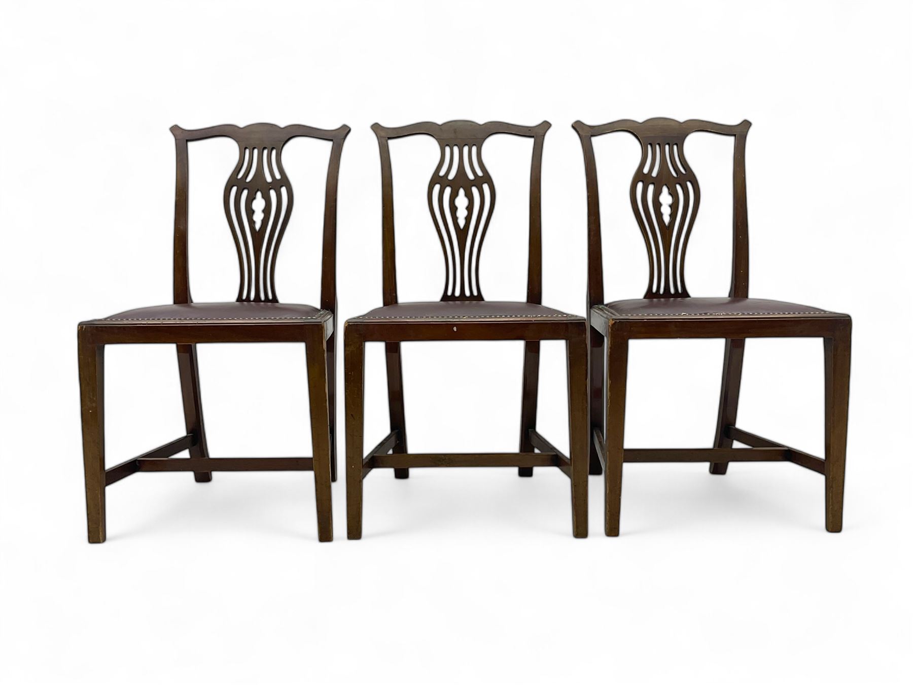 Set of six (4+2) 19th century Chippendale-design mahogany dining chairs, shaped cresting rail over pierced bulbous vase-shaped splat, burgundy leather upholstered seats with brass stud trim, on square tapering supports united by H-stretchers