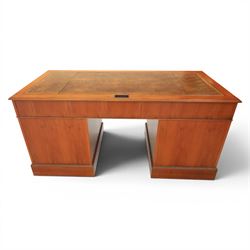 Georgian design yew wood twin pedestal office desk, the top featuring an inset leather writing surface, with drawer drawers and centre keyboard slide, all above two cupboards with slide out shelves