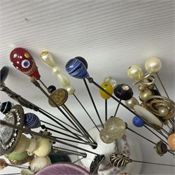 Collection of victorian and later hat pins, including a silver golf club example, hallmarked, glass and sequin examples, with various pin cushions  