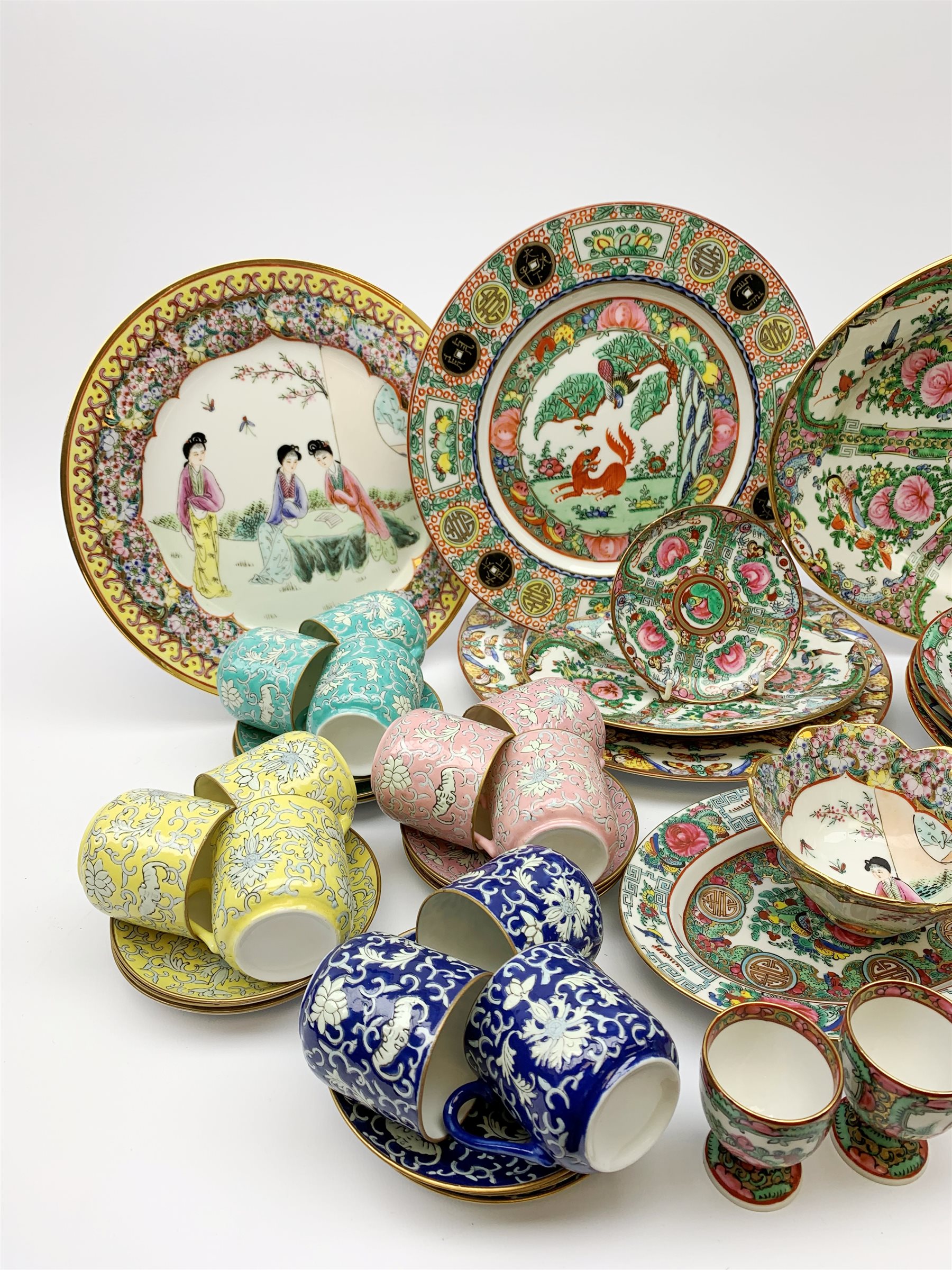 A Chinese tea set, comprising seven tea cups, eight saucers, eight side plates, sandwich plate