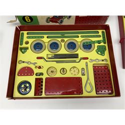 Meccano - Outfits 4, 6 & 7 with red and green parts; Outfits 4 & 6 virtually fully stocked and Outfit 7 containing large quantity of loose parts; Outfits 4 & 7 with instruction manuals; all boxed (3)