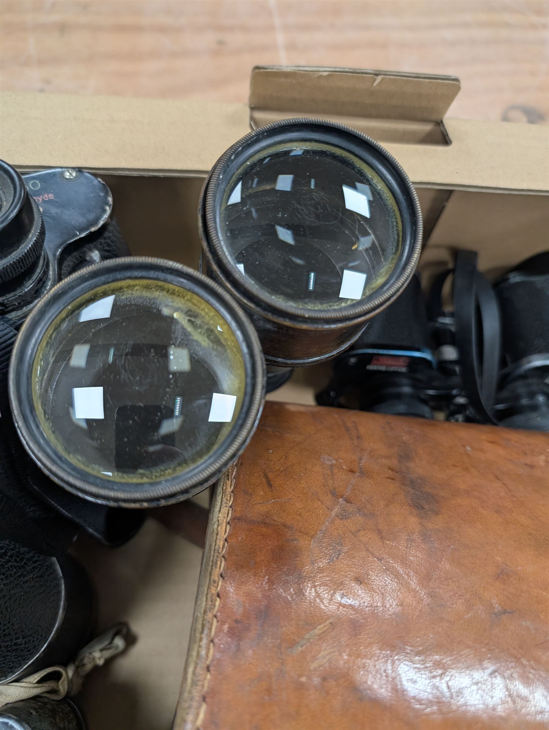 Nine pairs of early 20th century and later binoculars, including Tento 20x50, Nagoya Panoramic 8 x 30, Orr & Sons Madras, DRW 10 x 50, etc some with cases
