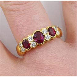 18ct gold three stone oval ruby and eight stone round brilliant cut diamond ring, London 2008