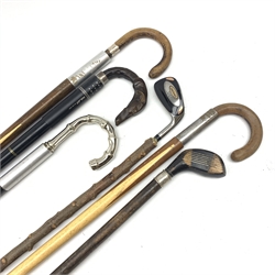 Six assorted walking sticks, four with snooker cue canes, to include an example with handle modelled as the head of a grey hound, another with silver mounted band, hallmarked London 1939, maker's mark worn and indistinct, and two with golf club handles. (4). 