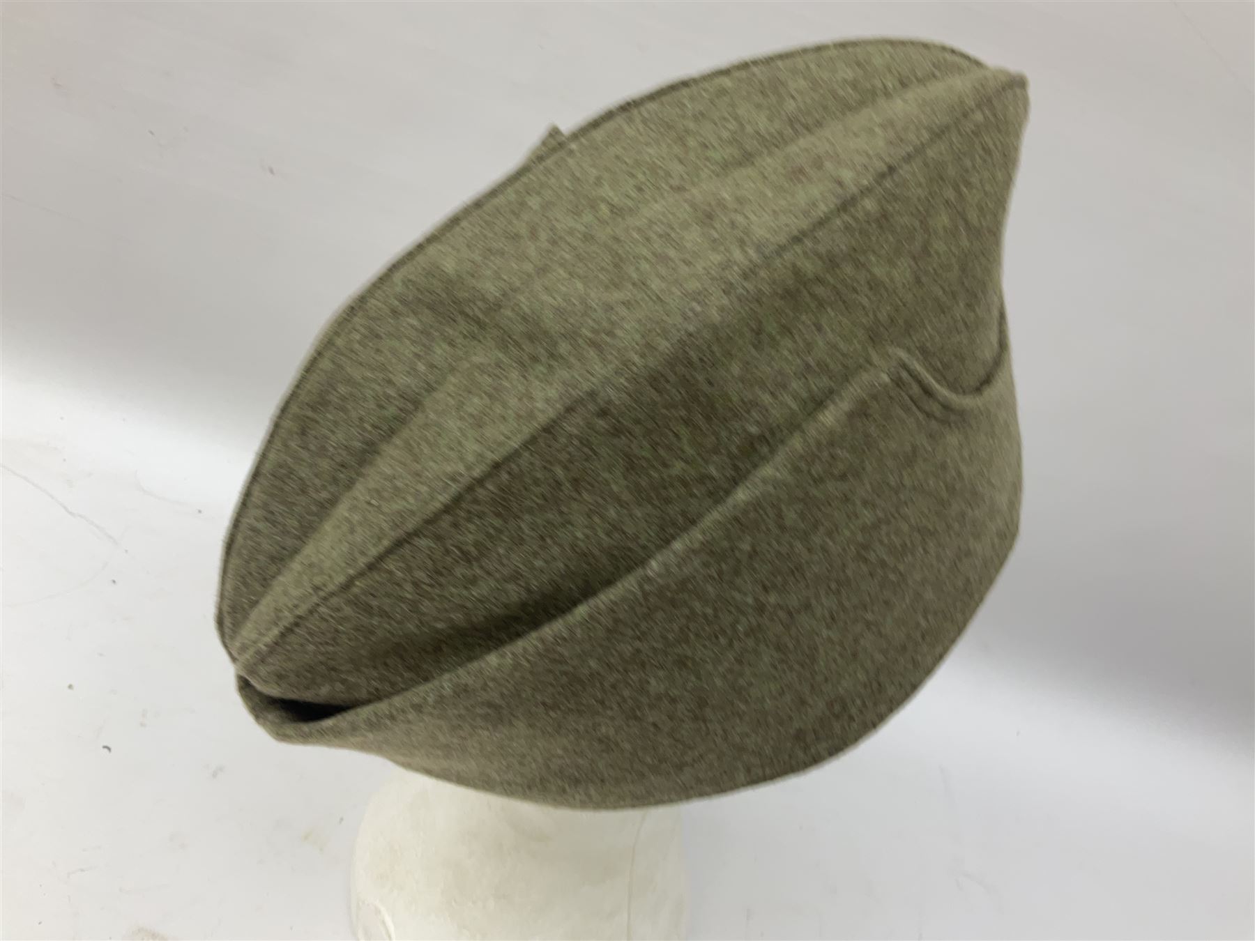 Five reproduction German WW2 hats comprising Wehrmacht olive tropical helmet, Heer officer's peaked cap, two M43 caps and Field side cap (5)
